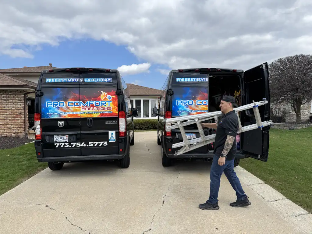 Pro Comfort Solutions technician on a ladder servicing a commercial HVAC unit