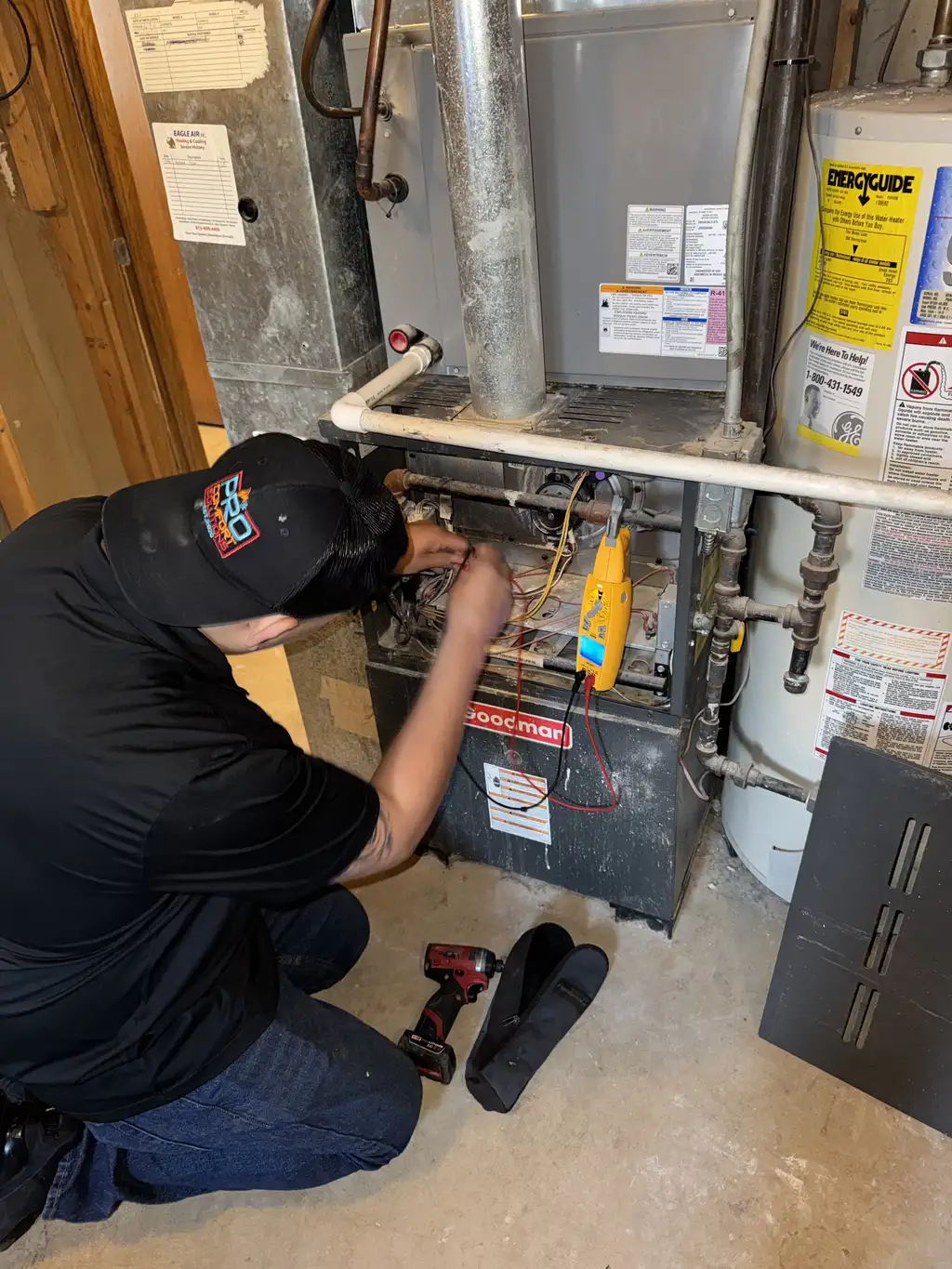 Pro Comfort Solutions technician servicing a residential water heater